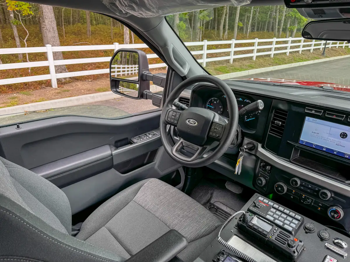 Top-down center-console view showing switch bank, radios, and control labels.